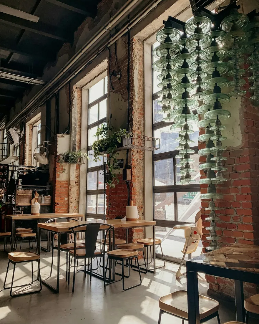A sunlit cafe with wooden tables